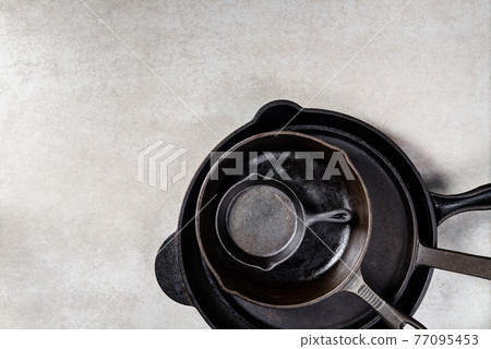 Cast iron Pans or Skillets on Grey Background 77095453