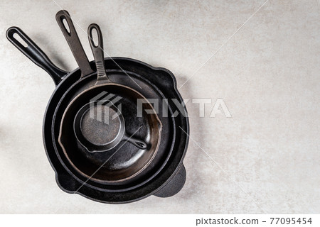 Cast iron Pans or Skillets on Grey Background 77095454