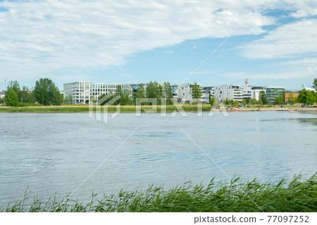 Toolo Bay in City Park, Helsinki, Finland. Across the water are new residential buildings Toolo Bay in City Park, Helsinki, Finland. Across the water are new residential buildings 77097252