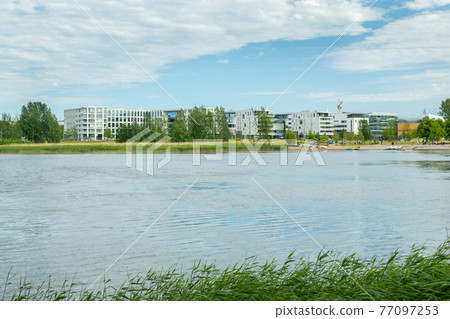 Toolo Bay in City Park, Helsinki, Finland. Across the water are new residential buildings Toolo Bay in City Park, Helsinki, Finland. Across the water are new residential buildings 77097253