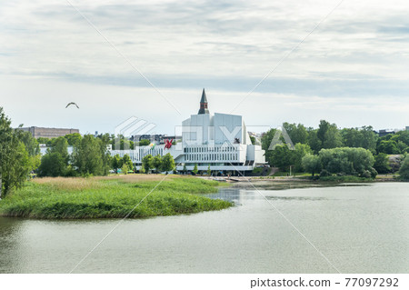 Helsinki, Finland - June 12, 2019: Toolo bay in the City Park in Helsinki, Finlandia Hall congress and event venue can be seen across the water 77097292