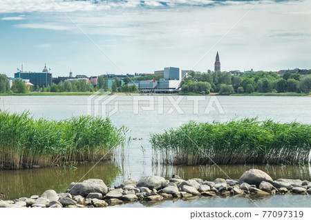Helsinki, Finland - June 12, 2019: Toolo bay in the City Park in Helsinki, Finlandia Hall congress and event venue can be seen across the water 77097319