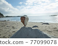 I tried to pile stones on the stones on the sandy beach 77099078