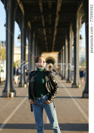 Young blonde girl walking in european city, Milan. 77099382