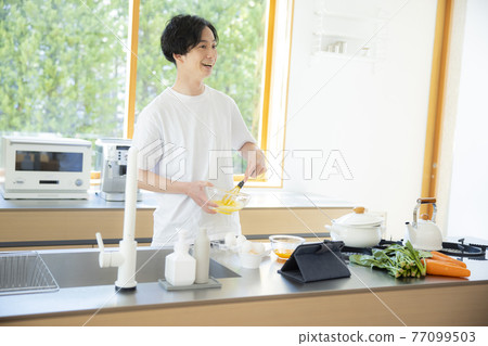 A man in the kitchen A man in the kitchen 77099503