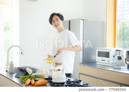 A man in the kitchen A man in the kitchen 77099504