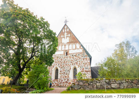 Hollola, Finland - 9 September 2019: Old medieval stone church of St. Mary in Hollola, Finland 77099899