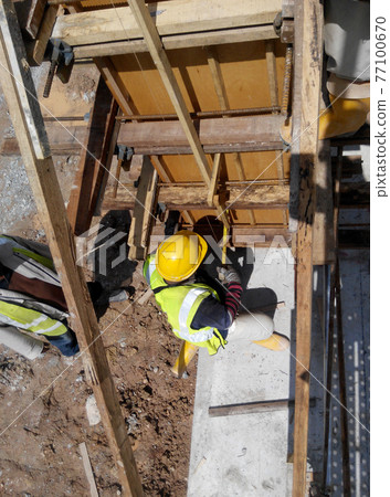 MALACCA, MALAYSIA -SEPTEMBER 19, 2016: Column timber form work and reinforcement bar at the construction site in Malacca, Malaysia. The structure supported by temporary wood support MALACCA, MALAYSIA -SEPTEMBER 19, 2016: Column timber form work and reinforcement bar at the construction site in Malacca, Malaysia. The structure supported by temporary wood support 77100670