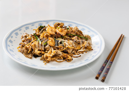 Serving of simple penang char kuey teow is popular fried noodle with coceral, shrimp and eggs in black sauce in Malaysia Serving of simple penang char kuey teow is popular fried noodle with coceral, shrimp and eggs in black sauce in Malaysia 77101428