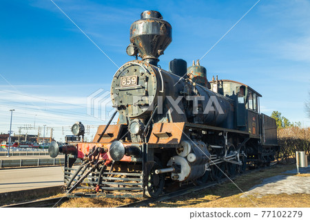 Kouvola, Finland - April 18, 2019: Old steam locomotive as an exhibit at the Kouvola railway station in Finland. 77102279