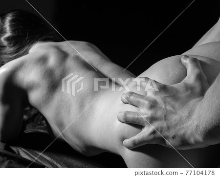 Black and white image of a sexual young couple in the shadows 77104178