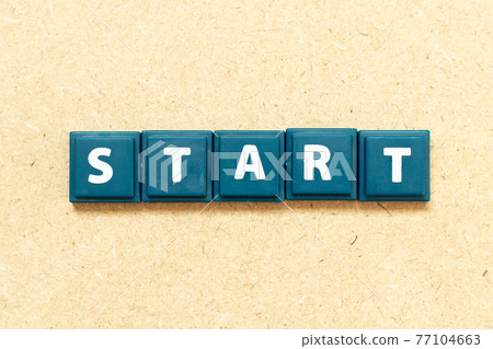 Tile alphabet letter in word start on wood background Tile alphabet letter in word start on wood background 77104663