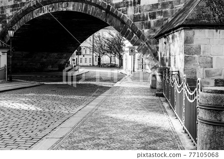 Cobbled street under the bridge 77105068