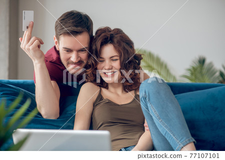 A couple spedning time at home and planning online shopping A couple spedning time at home and planning online shopping 77107101