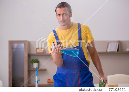 Young male contractor cleaning the house 77108651