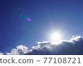 Image of blue sky and clouds with bright sun 77108721