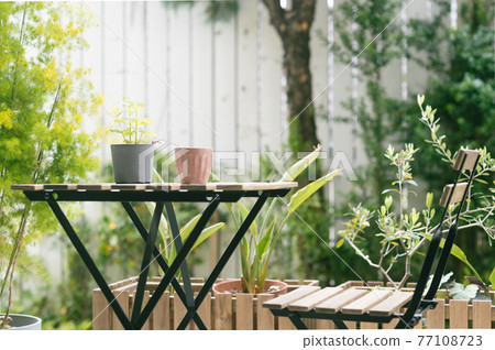 Tables and chairs on the lush terrace Tables and chairs on the lush terrace 77108723