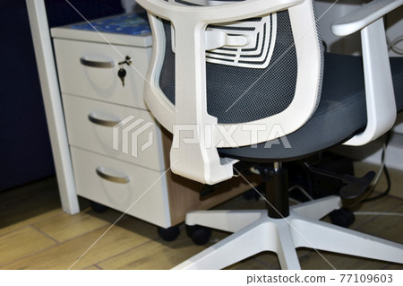Office white chair at the table in the hall 77109603