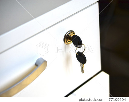 White office nightstand with a key in the lock White office nightstand with a key in the lock 77109604
