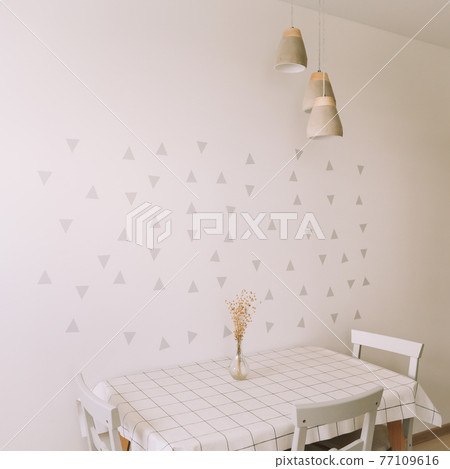 Modern dining room with a table with flowers and chairs. Comfortable cozy kitchen interior Modern dining room with a table with flowers and chairs. Comfortable cozy kitchen interior 77109616