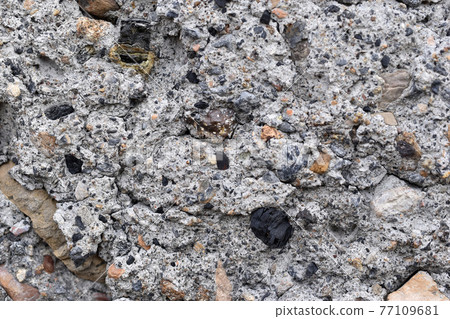 The surface of an old cinder block falling apart The surface of an old cinder block falling apart 77109681