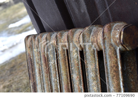 A rusty old Soviet radiator battery pack A rusty old Soviet radiator battery pack 77109690