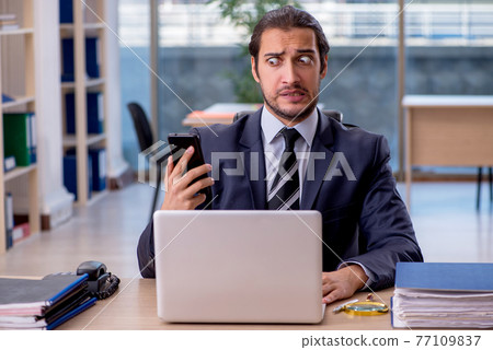 Young businessman employee working in the office Young businessman employee working in the office 77109837
