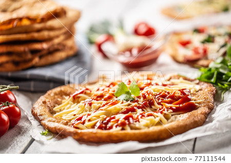 Original hungarian langos with grated cheese and 77111544