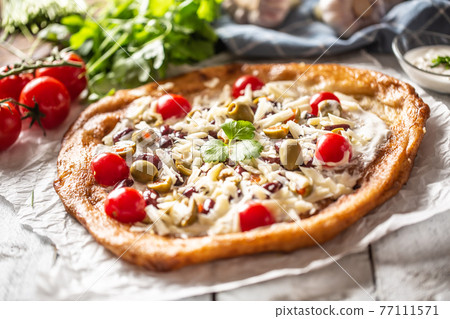 Tasty and crusty langos perfectly served with 77111571