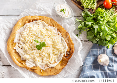 Precisely prepared hungarian traditional langos 77111601