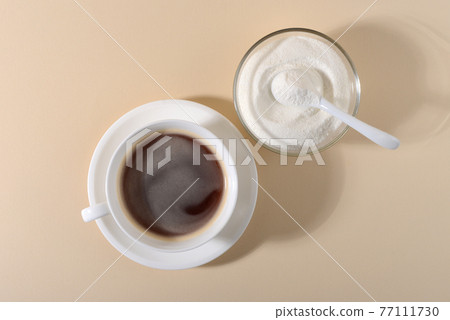 Collagen powder and cup of coffee on beige background. 77111730
