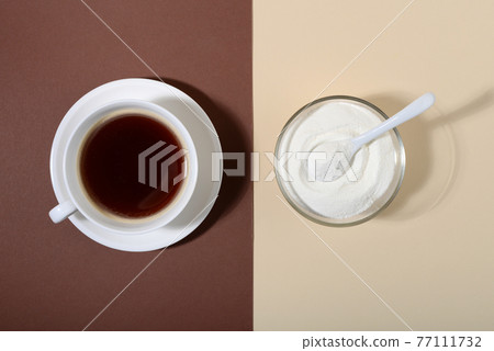 Collagen powder and cup of coffee on two tone background. 77111732