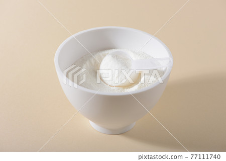 Collagen powder on beige background. 77111740
