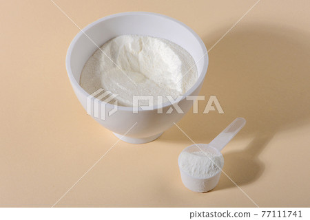 Collagen powder on beige background. 77111741