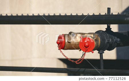 Close up picture of a standpipe on a street of New York, selective focus, USA. Close up picture of a standpipe on a street of New York, selective focus, USA. 77112526