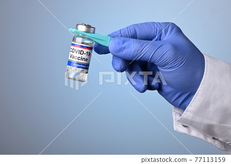 Doctor Hand Holds Covid-19 Vaccine with Pincet Doctor Hand Holds Covid-19 Vaccine with Pincet 77113159