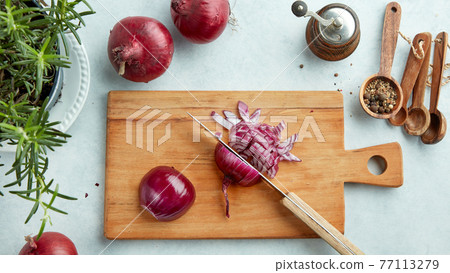 chopped red onions on wooden cutting board chopped red onions on wooden cutting board 77113279