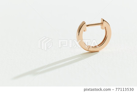 gold earring on a white background 77113530