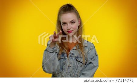 Teen stylish girl pointing at her eyes and camera, show I am watching you gesture, spying on someone Teen stylish girl pointing at her eyes and camera, show I am watching you gesture, spying on someone 77114775