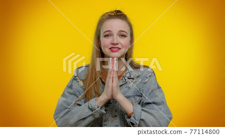 Teen student girl praying, looking upward and making wish, asking God for help, begging apology Teen student girl praying, looking upward and making wish, asking God for help, begging apology 77114800
