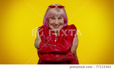 Mature old granny grandmother spread hands and give hug to you, pleasant expression, love feelings Mature old granny grandmother spread hands and give hug to you, pleasant expression, love feelings 77115405