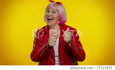 Elderly old woman granny celebrate success win scream rejoices doing winner hands gesture say Yes 77115455