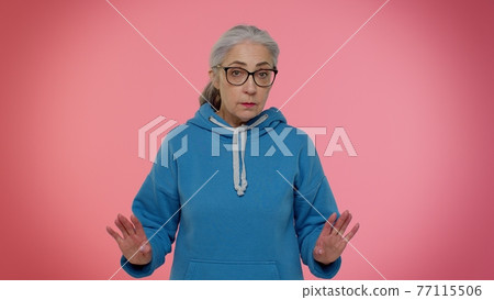Displeased unpleasant upset senior grandmother wave hand, shake head dismiss idea dont like proposal Displeased unpleasant upset senior grandmother wave hand, shake head dismiss idea dont like proposal 77115506