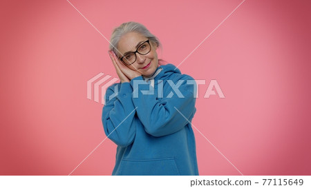 Lazy elderly woman yawning, sleepy inattentive feeling somnolent bored, suffering from lack of sleep Lazy elderly woman yawning, sleepy inattentive feeling somnolent bored, suffering from lack of sleep 77115649