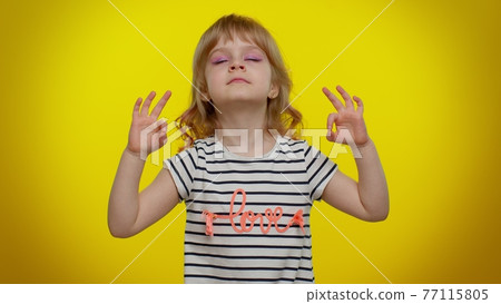 Child kid girl breathes deeply with mudra gesture, eyes closed, meditating, keep calm down, relax 77115805