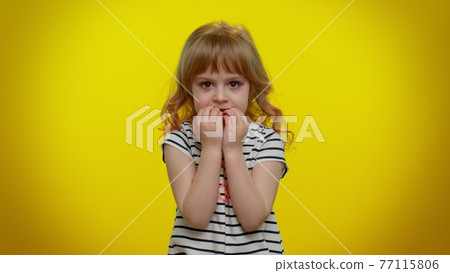 Upset scared child girl biting nails, feeling worried nervous, serious troubles, stress, anxiety Upset scared child girl biting nails, feeling worried nervous, serious troubles, stress, anxiety 77115806