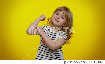 Little strong kid child girl showing biceps and feeling power strength, energy to gain success win 77115807