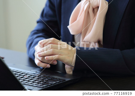 Woman in a suit putting her hands on the table Front of the upper body 77116919
