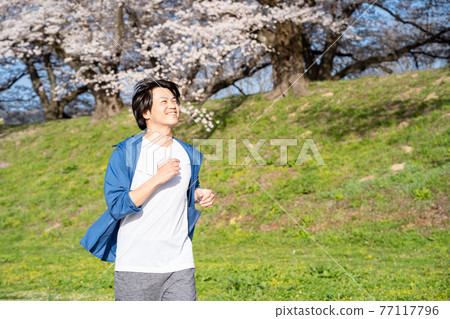 Man jogging in the park 77117796