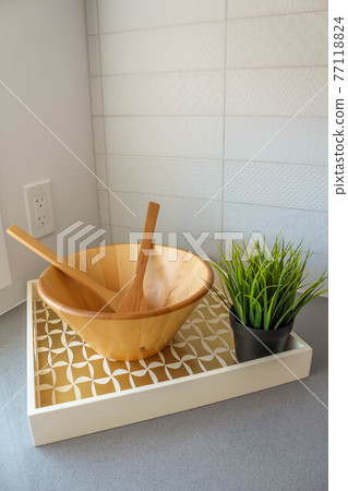 Empty wooden salad bowl on the kitchen table. Interio decor Empty wooden salad bowl on the kitchen table. Interio decor 77118824